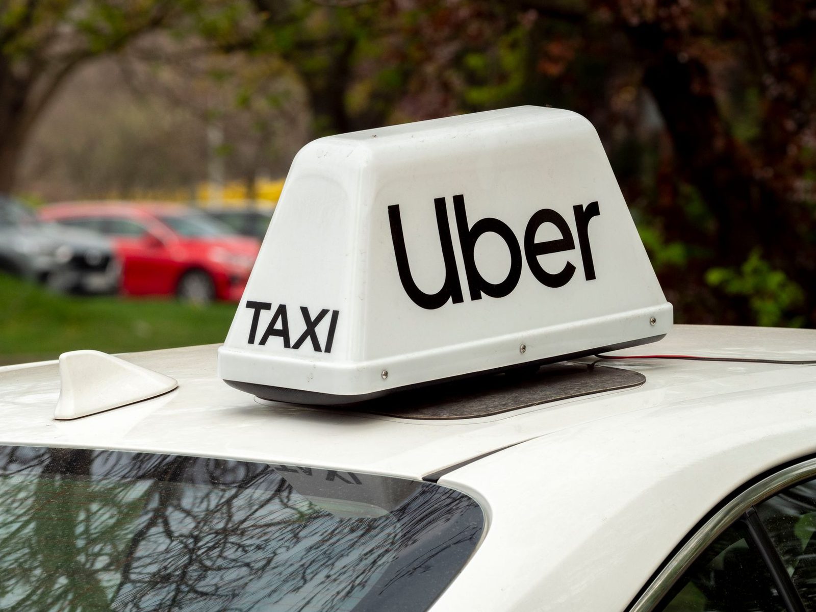 A close-up of a white Uber sign on a car roof, taken in Wrocław, Poland.