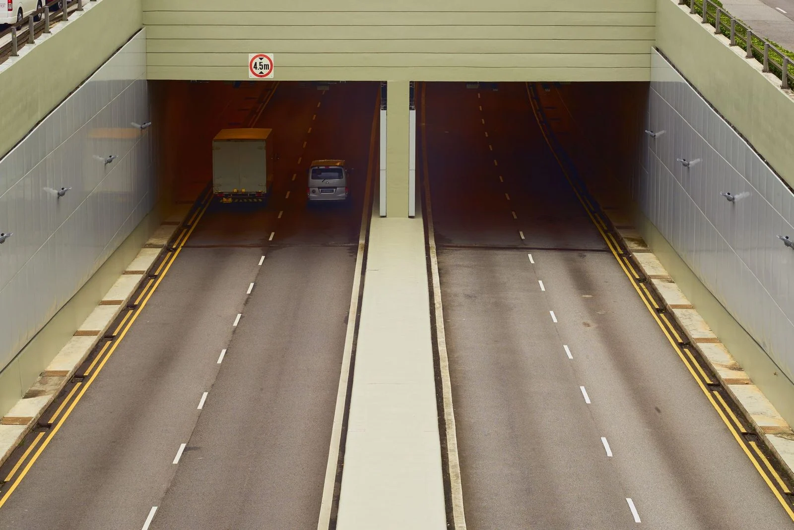 Aerial view of a highway tunnel with clear lanes and minimal traffic.