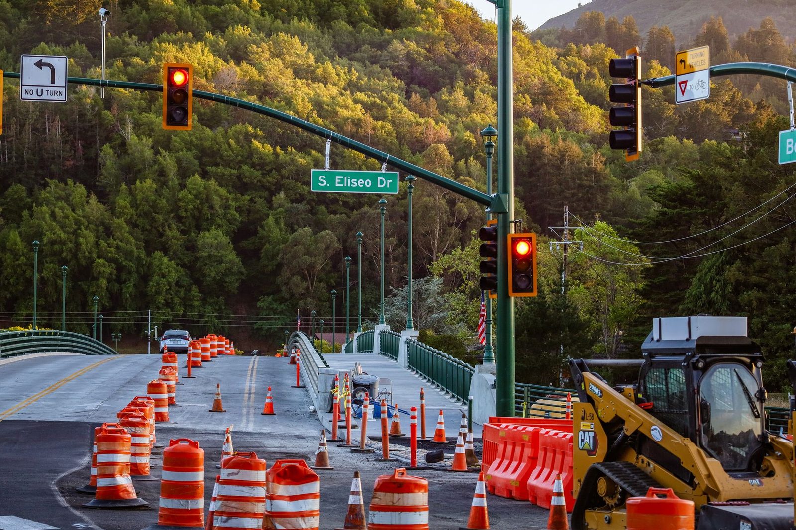 Road construction along S. Eliseo Drive with traffic signals and warning signs.